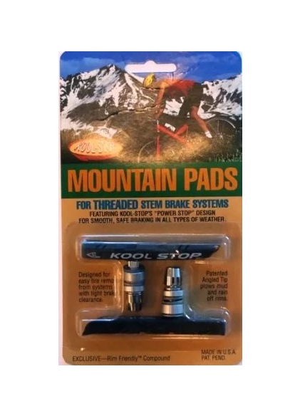 A set of Kool Stop Mountain Brake Pads are shown with their mounting bolts in their retail packaging