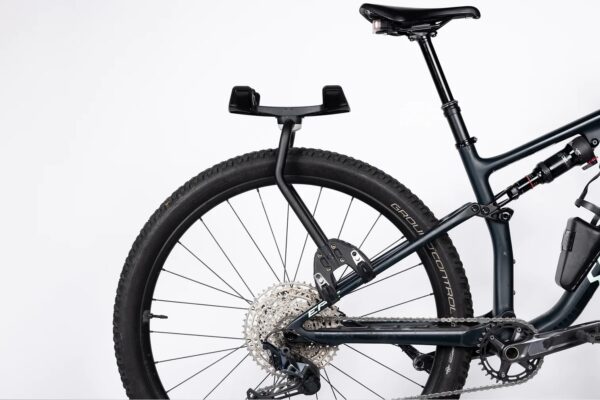 An Aeroe Spider Rear Rack is shown in black powder finish fitted to the seat stays of a dual suspension mountain bike