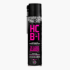 A tall black spray bottle of Muc-Off HCB-1 is shown with big pink font on the front describing it as a Harsh Condition Barrier