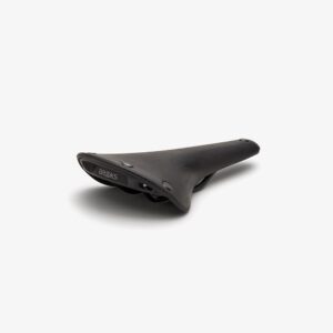 An all black rubber Brooks C17 saddle is shown resting on a white background