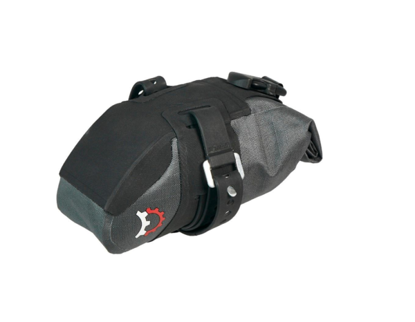 A black & grey Revelate Stoat bicycle seat bag is showns with rubberized straps and velcro holding it in a rolled, compressed package