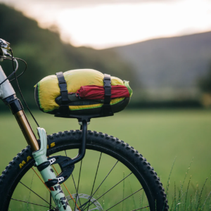 An Aeroe Spider Front Rack is shown fitted to a suspension fork with a dry bag strapped on to a Cradle on the rack