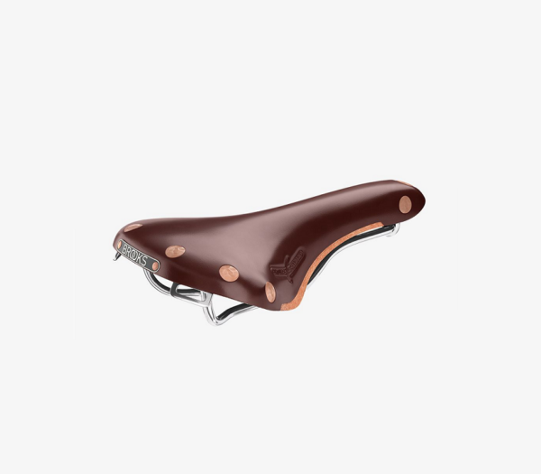 A brown leather Brooks Swift saddle is shown with copper rivets & steel railing visible beneath it