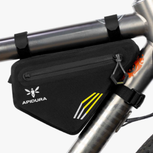 A small black Apidura Racing Frame Pack 1L is shown fitted via black velcro straps to a titanium framed bicycle