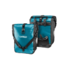 A set of Ortlieb Sport-Roller bicycle panniers are shown back to back with black shoulder straps & mounting hardware on the rear, and a Petrol-blue tarpaulin material on the front & back