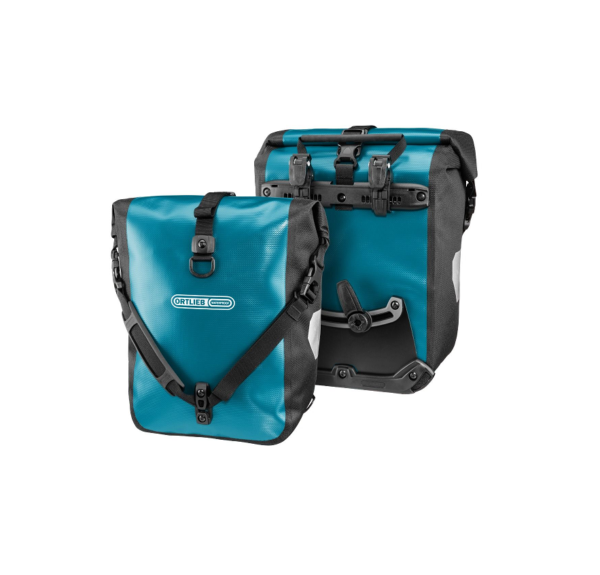 A set of Ortlieb Sport-Roller bicycle panniers are shown back to back with black shoulder straps & mounting hardware on the rear, and a Petrol-blue tarpaulin material on the front & back